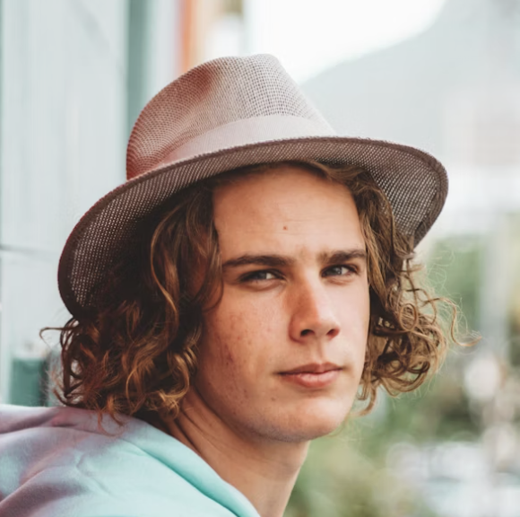 Young man wearing fedora hat